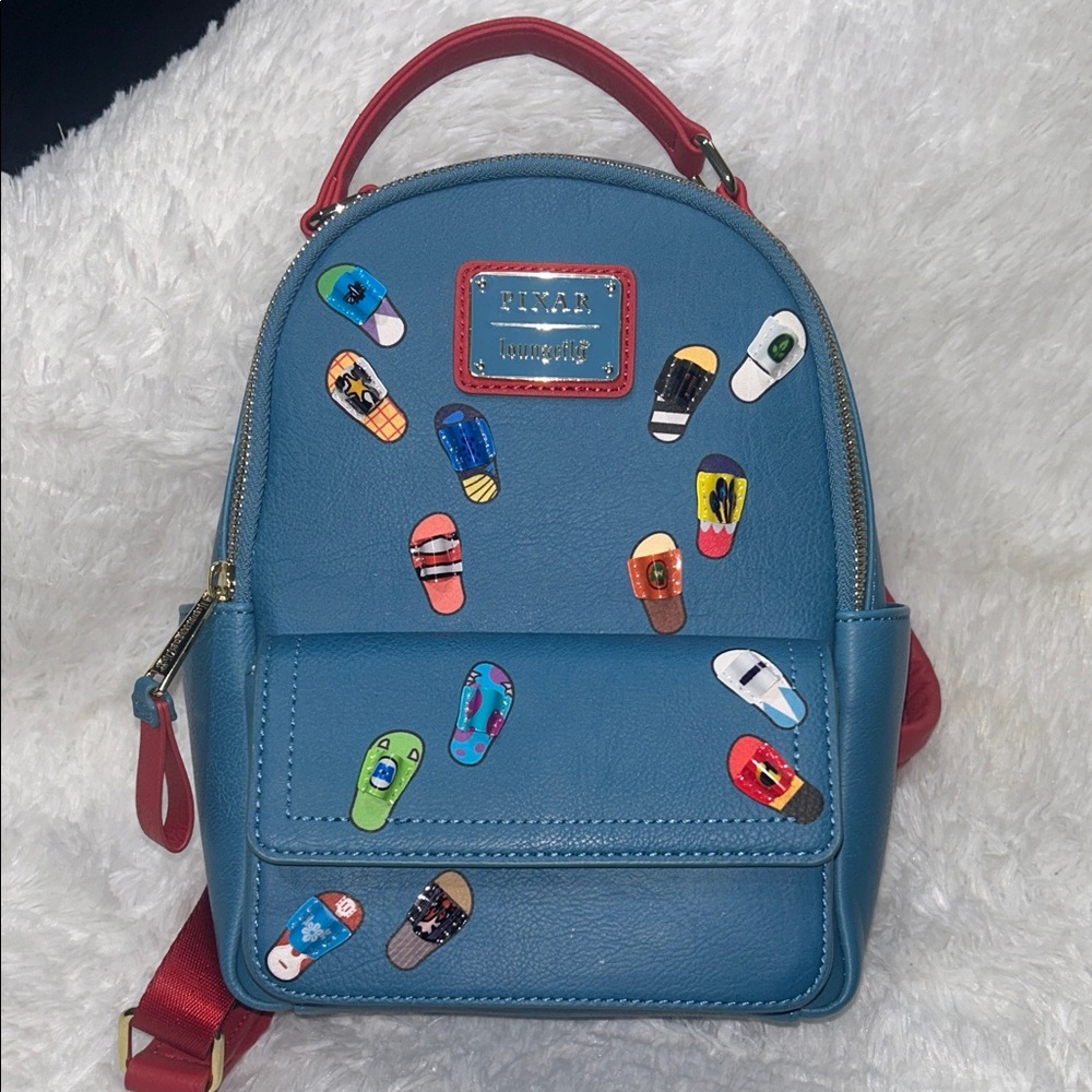 Loungefly Pixar Blue Backpack with Red and Gold Details